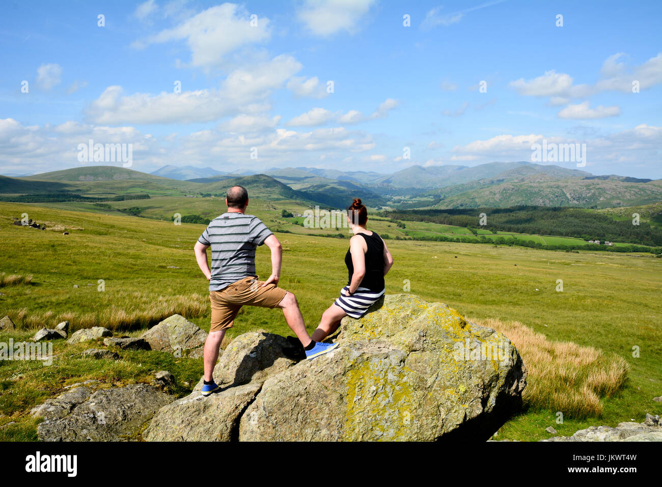 People looking at the view northwards of the Lake District taken near Lowick in Cumbria England Stock Photo