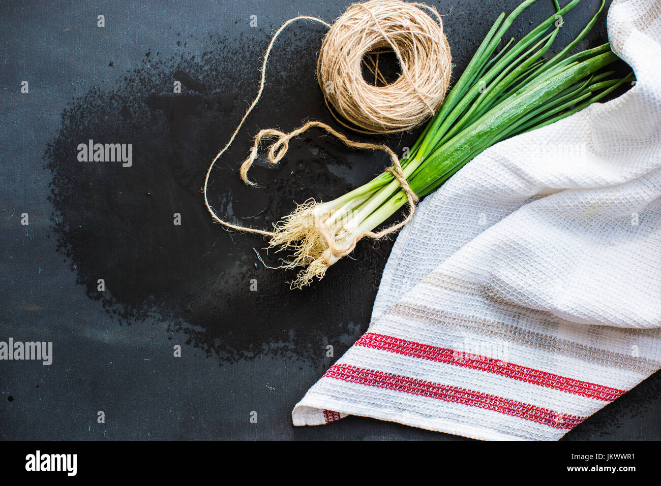 Organic green onion on dark board Stock Photo - Alamy