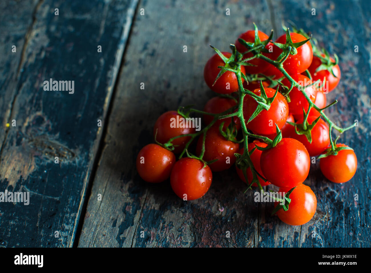 Fresh organic cherry tomatoes on dark wooden table Stock Photo - Alamy