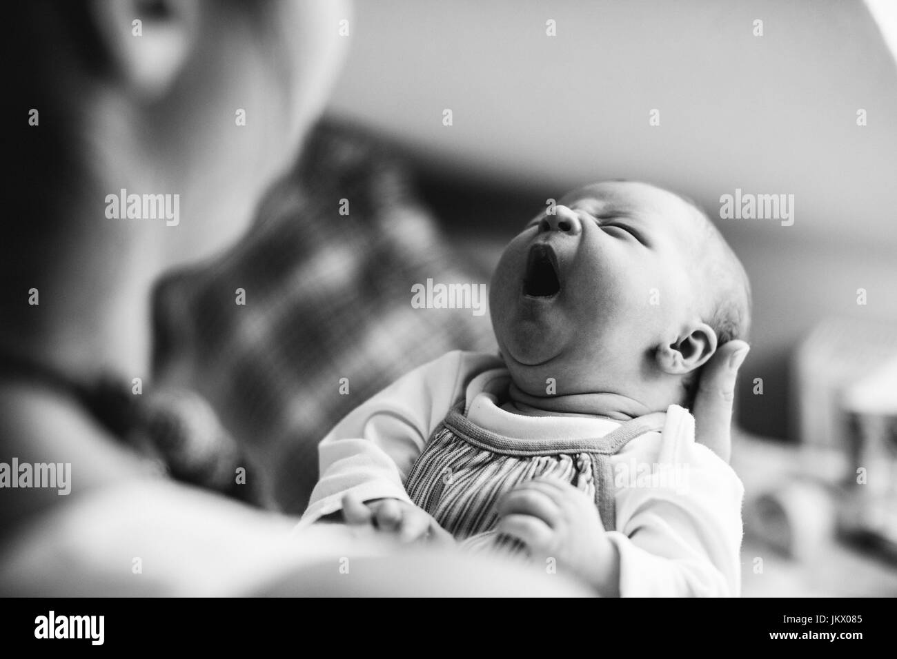 Unrecognizable mother holding crying newborn baby girl. Stock Photo