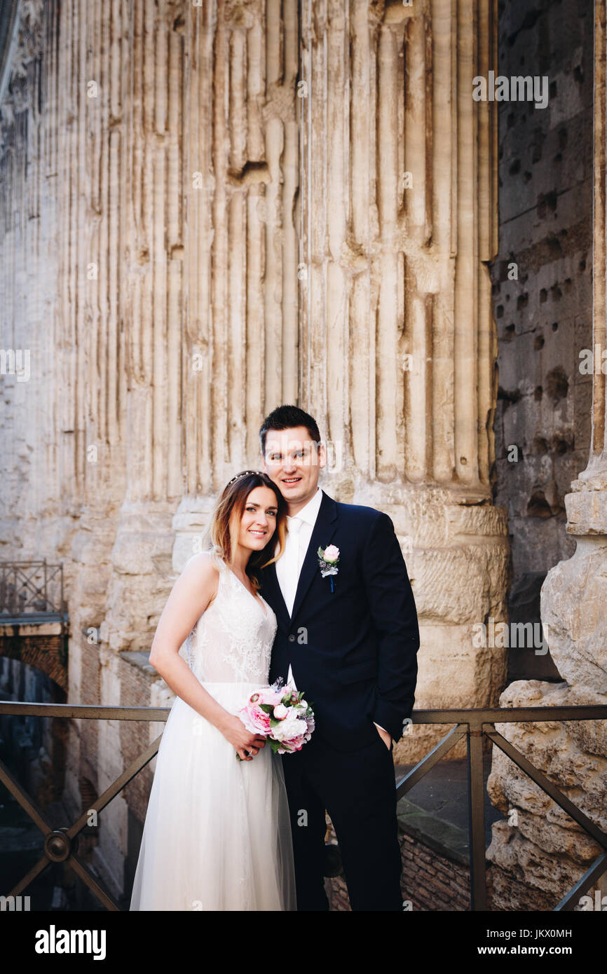 Bride and groom posing on the old streets of Rome, Italy Stock Photo ...