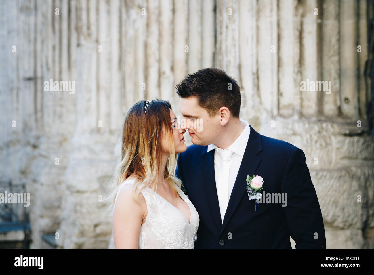 Bride and groom posing on the old streets of Rome, Italy Stock Photo ...