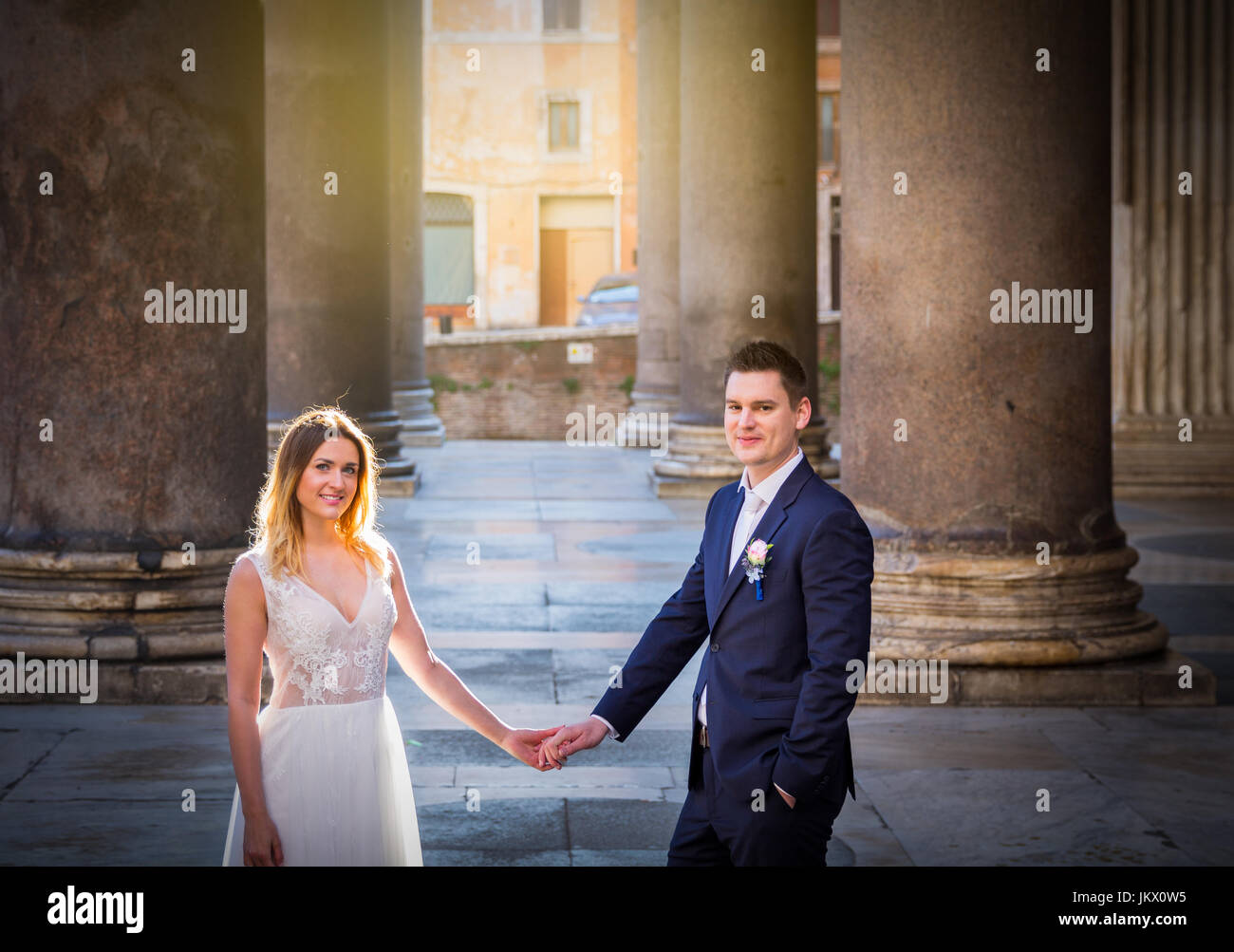 Bride and groom posing on the old streets of Rome, Italy Stock Photo ...