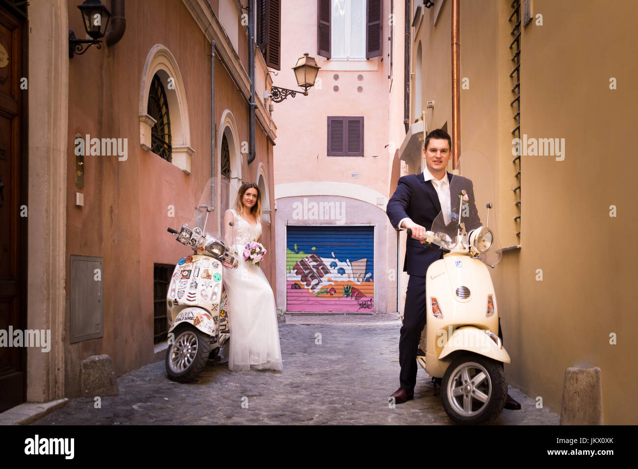 Bride and groom posing on the old streets of Rome, Italy Stock Photo ...