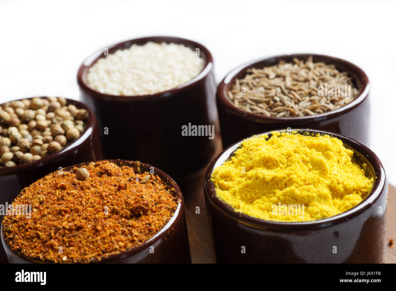Spices and herbs in ceramic bowls. seasoning. Colorful natural additives. Stock Photo