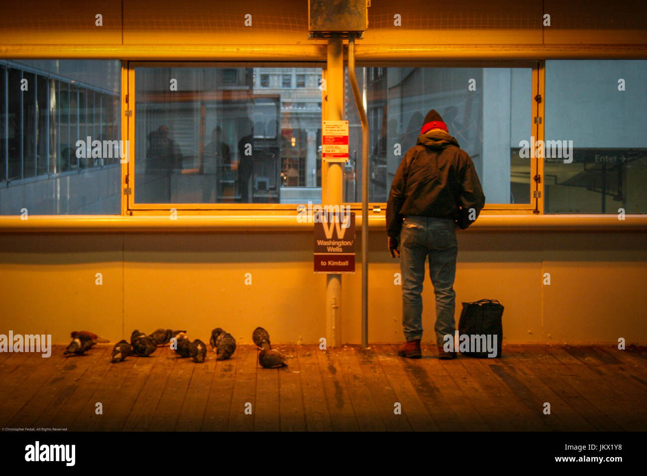 waiting for the subway, staying warm, looking out. Stock Photo