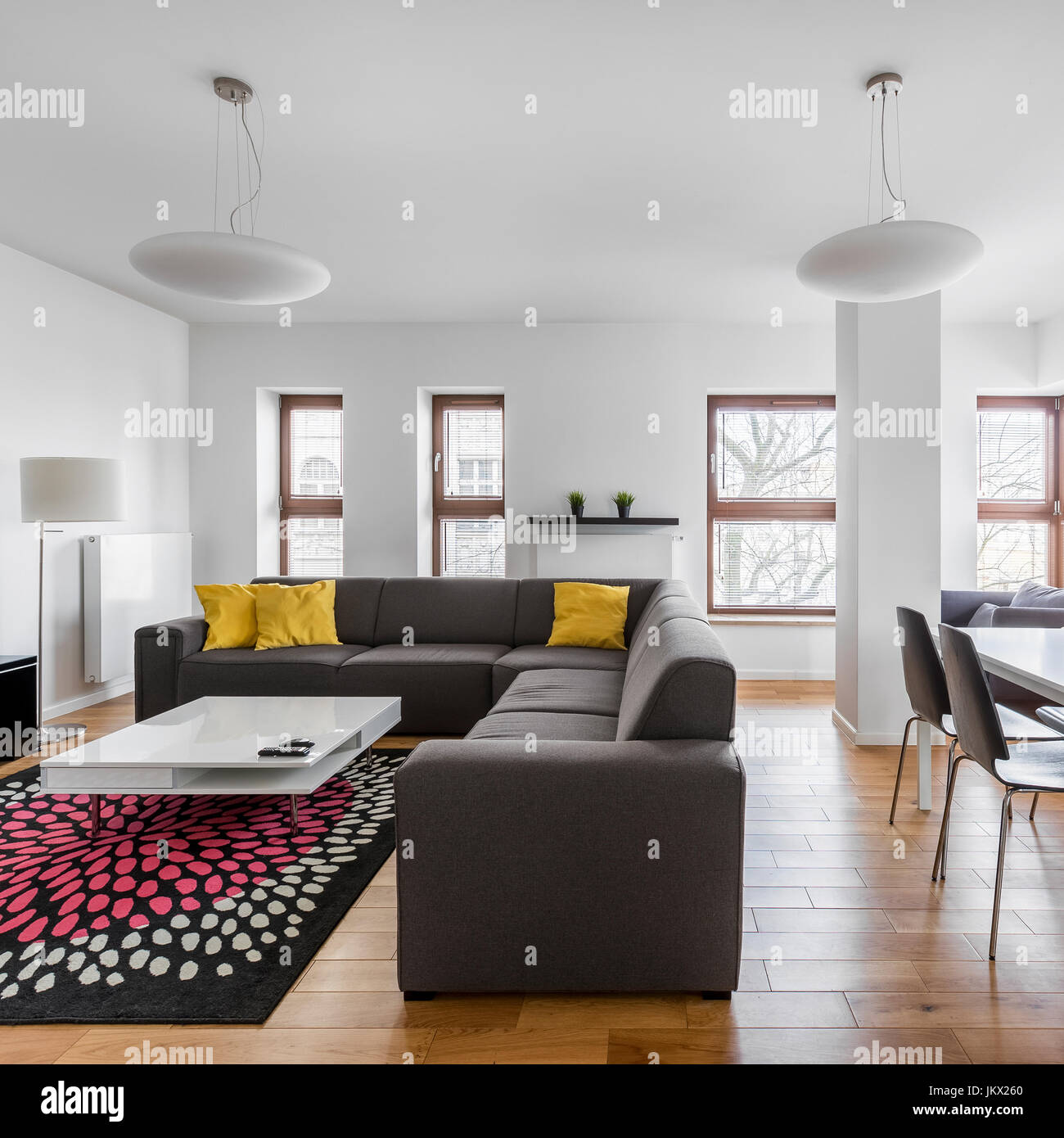 Modern living room with gray sofa and table Stock Photo - Alamy