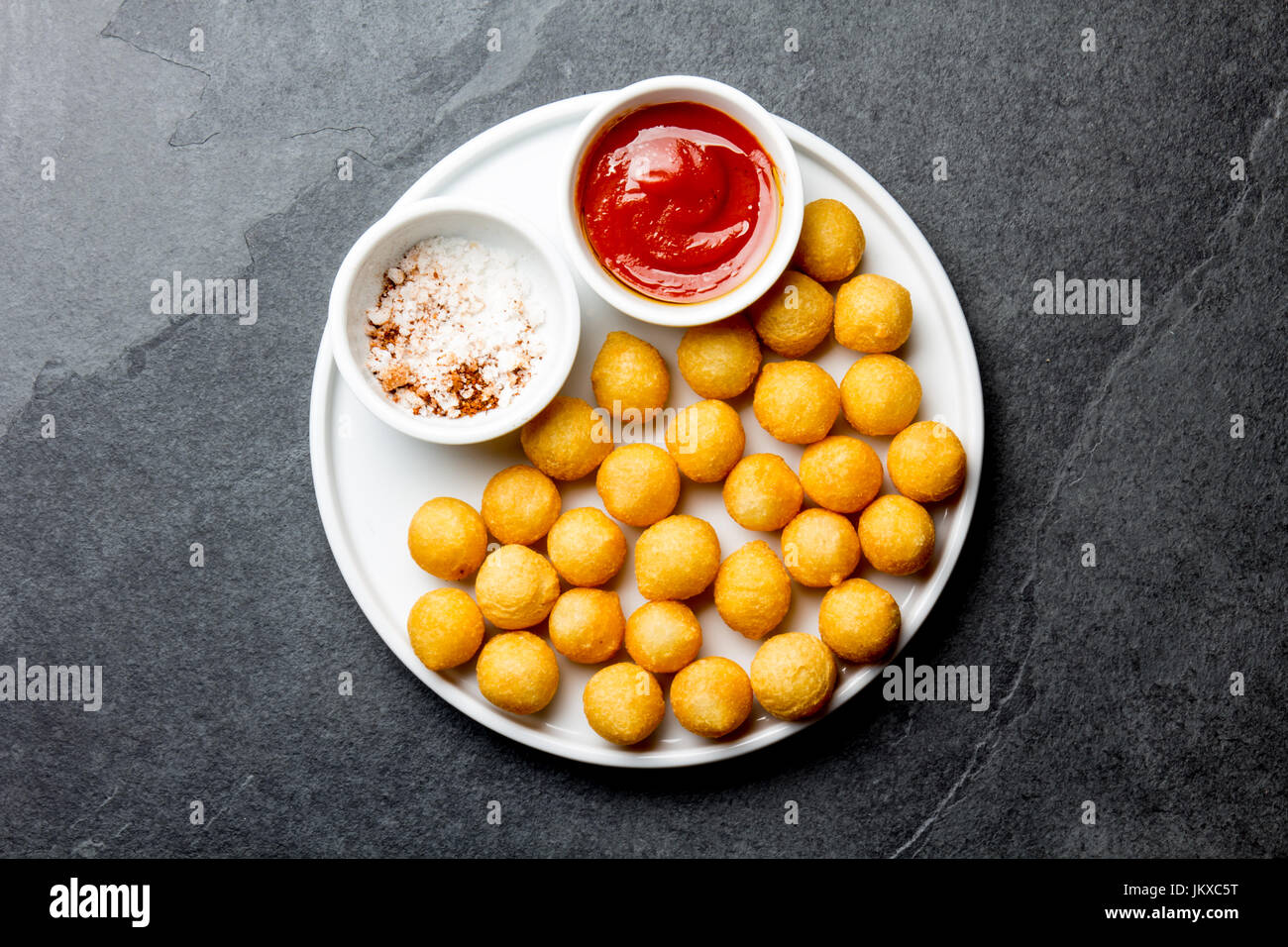 Close up of deep fried sweet potatoes ball on wooden background Stock