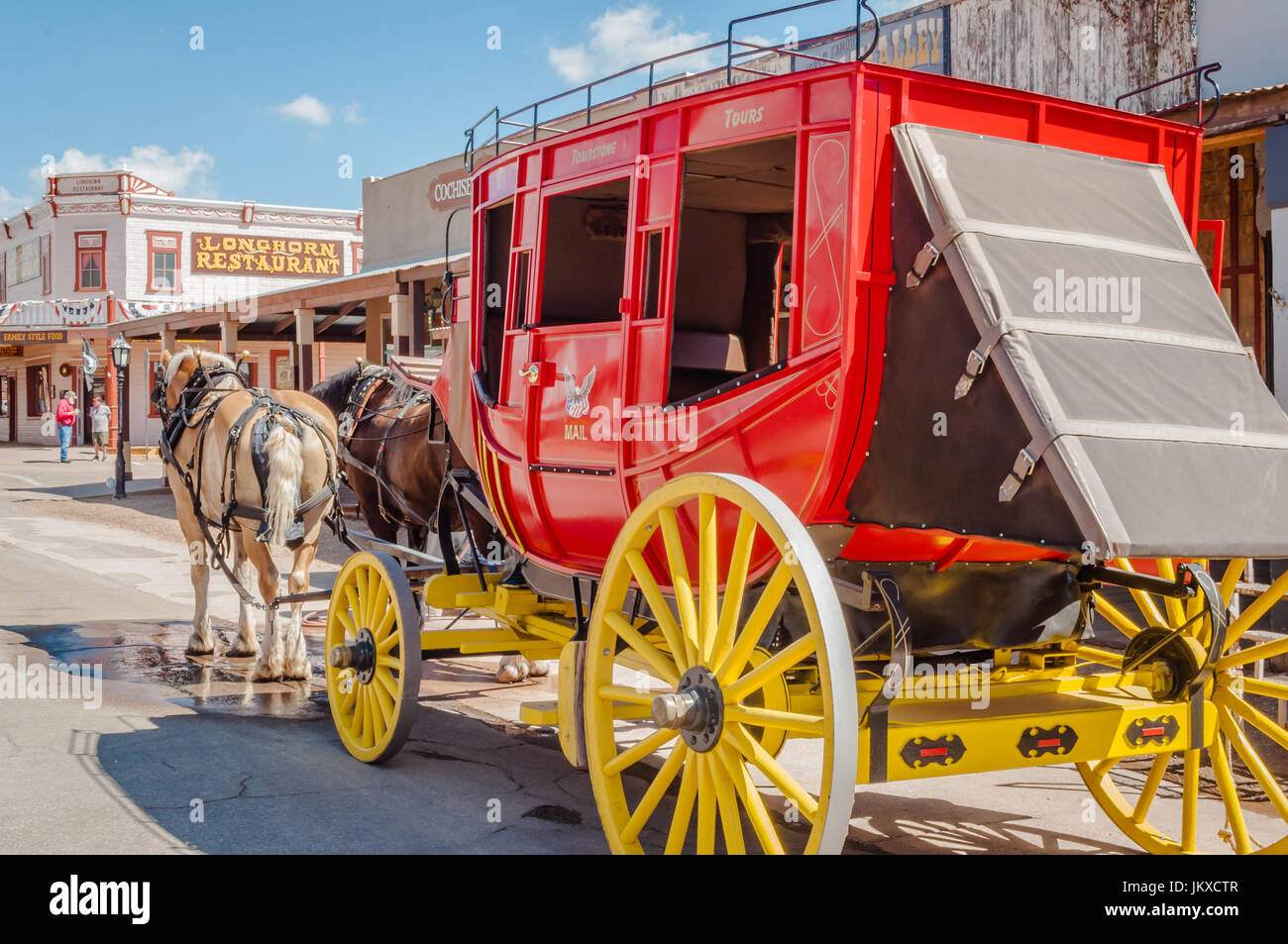 Horse drawn red stagecoach with yellow wheels Stock Photo