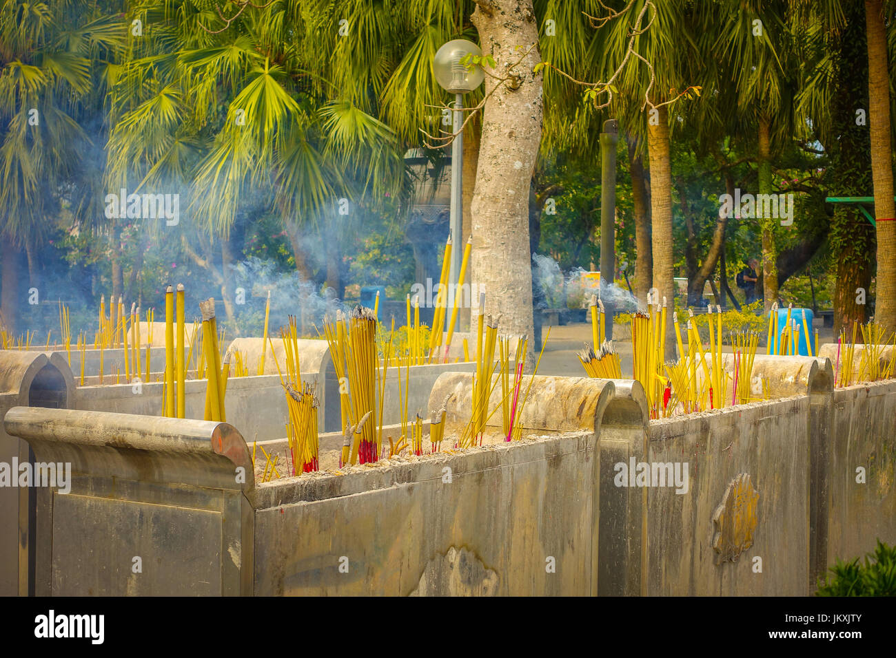Buddhist prayer sticks burning in the censer in Po Lin Monastery
