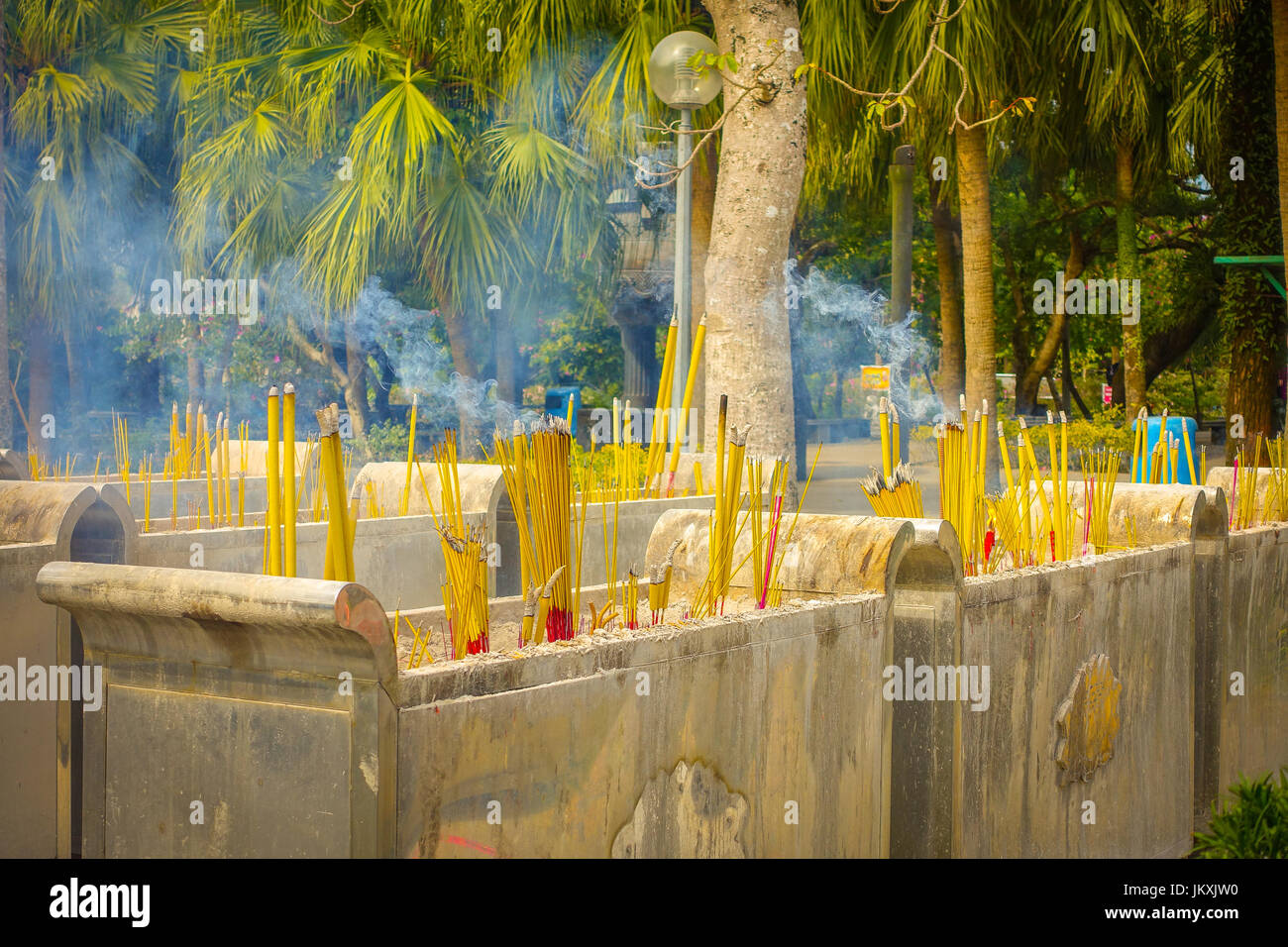 Buddhist prayer sticks burning in the censer in Po Lin Monastery
