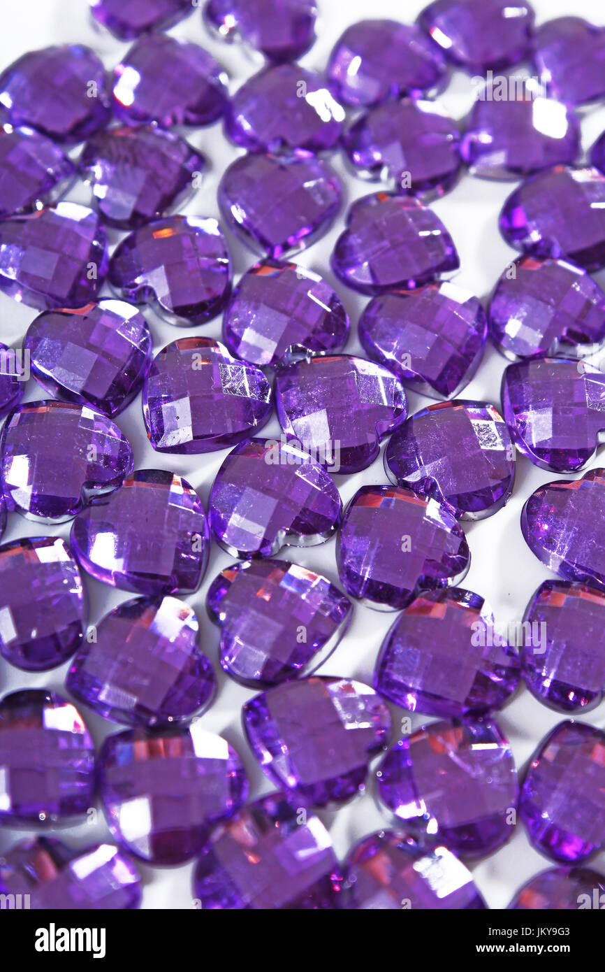 Rhinestone background. Heart shape texture as backdrop isolated white studio photo. Bling rhinestone crystal pattern. Rhinestones purple crystals Stock Photo
