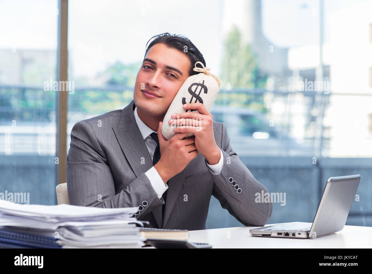 Businessman with money sack bag in office Stock Photo - Alamy