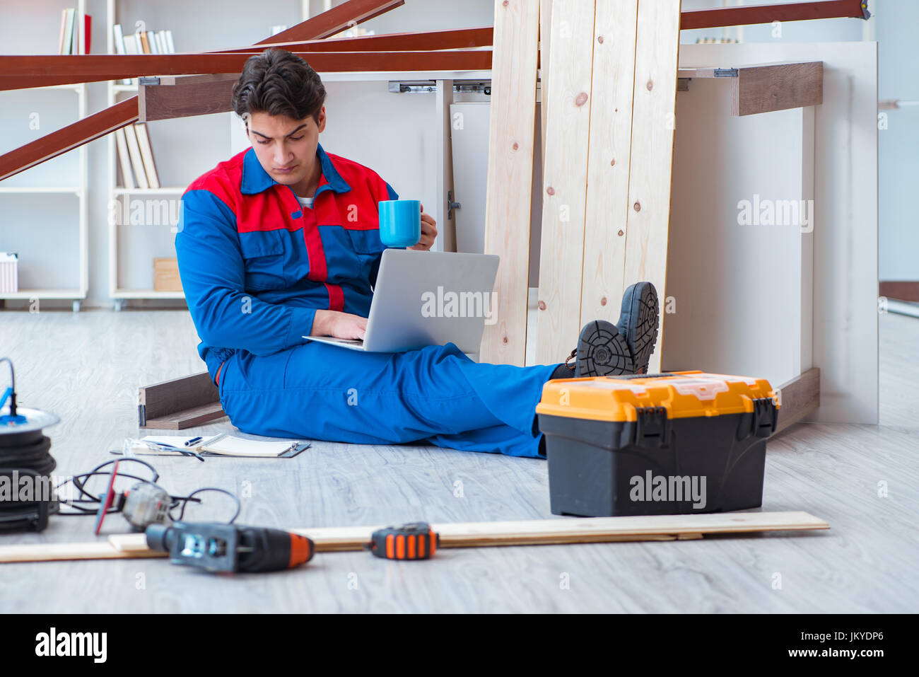 Young carpenter with a laptop computer Stock Photo - Alamy