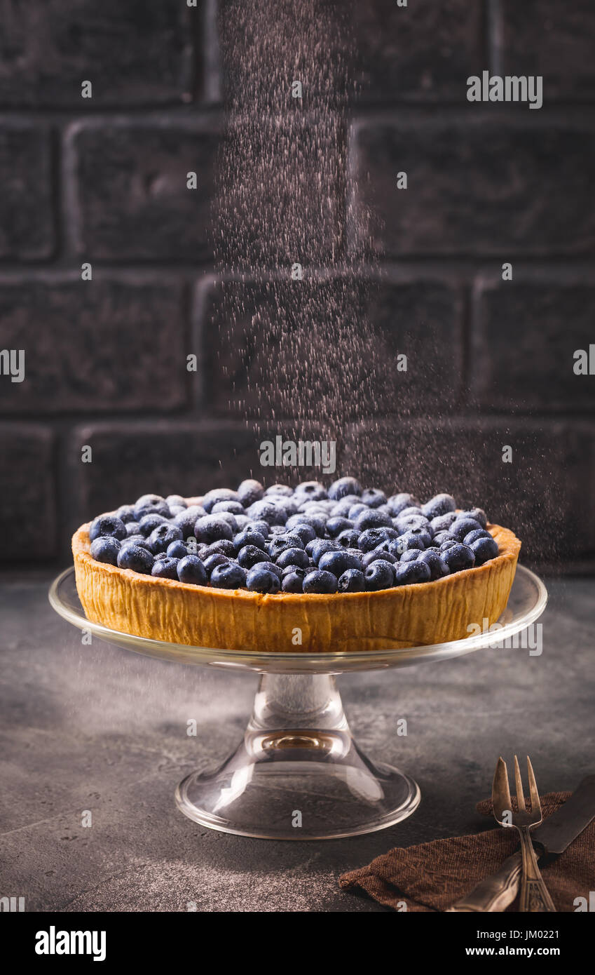 Sprinkle blueberry tart with icing sugar Stock Photo