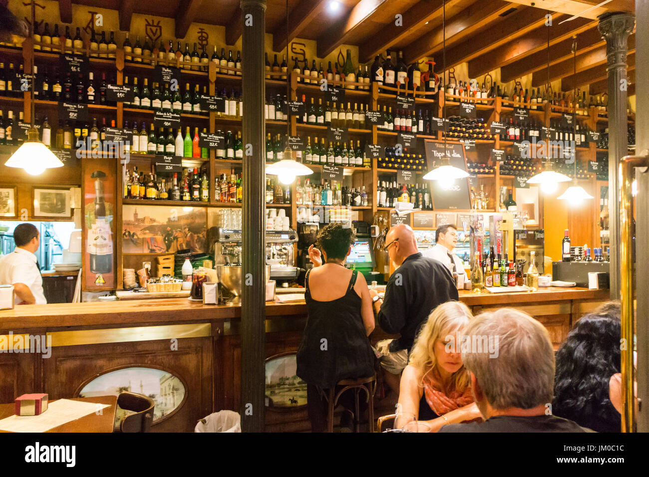 people drinking in a bar in old Seville, Spain Stock Photo