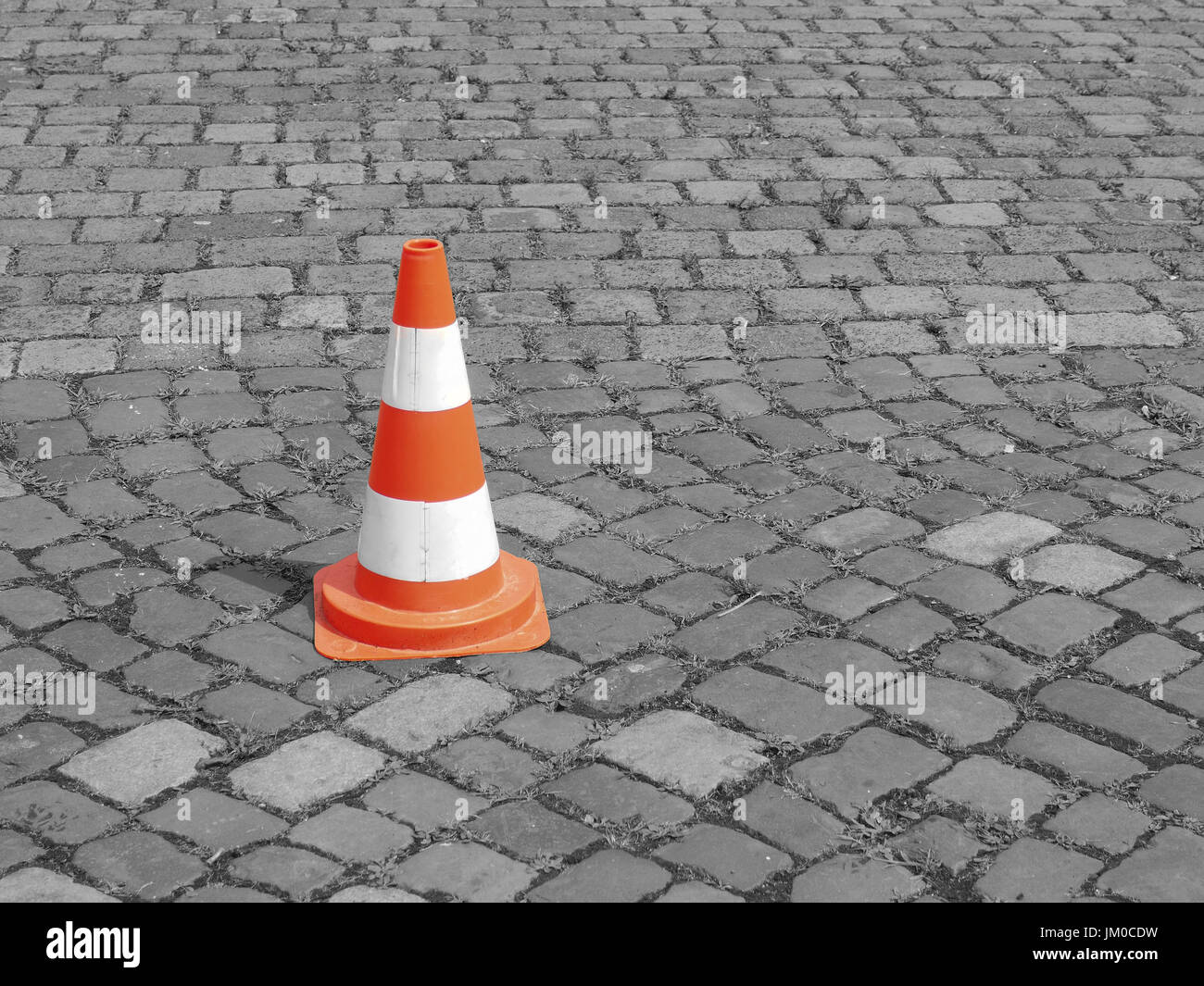 Pylon on a coblestone, secure or safety concept background with space