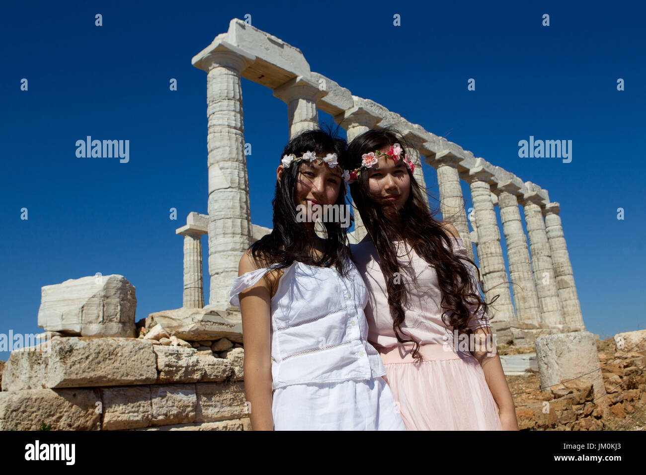 Chinese tourists visit the temple of Poseidon at cape Sounio. Stock Photo