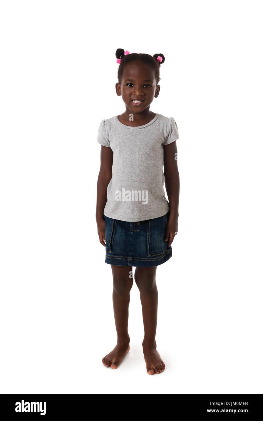 Cute African  little girl standing barefoot ,looking to the camera on white background Stock Photo