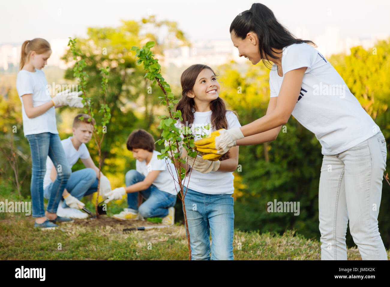 Charming kid showing friendly smile to her leader Stock Photo Alamy