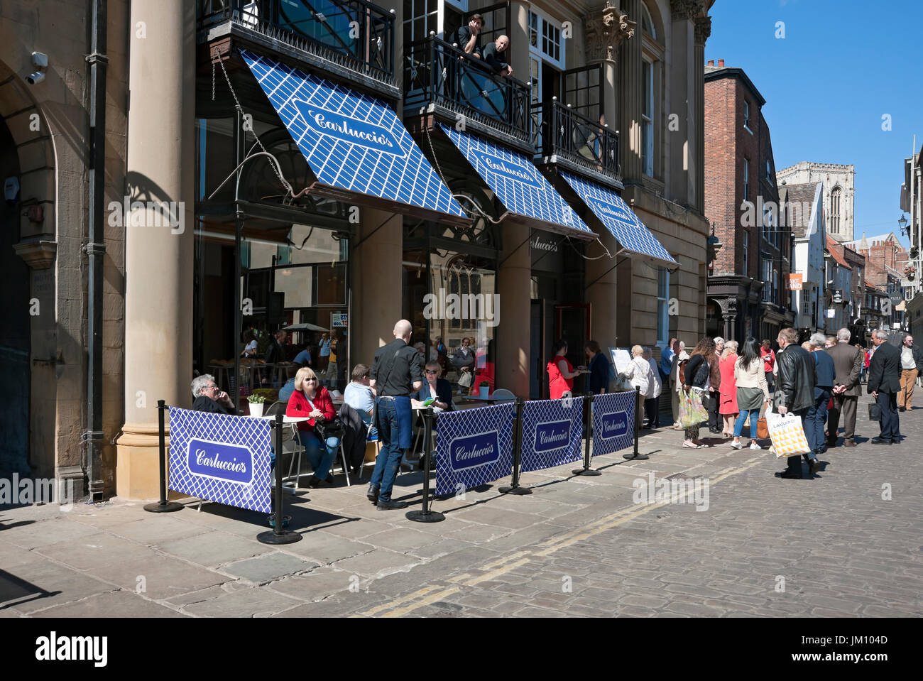 People sitting dining outside Carluccio's restaurant in spring St Helen's Square York North Yorkshire England UK United Kingdom GB Great Britain Stock Photo