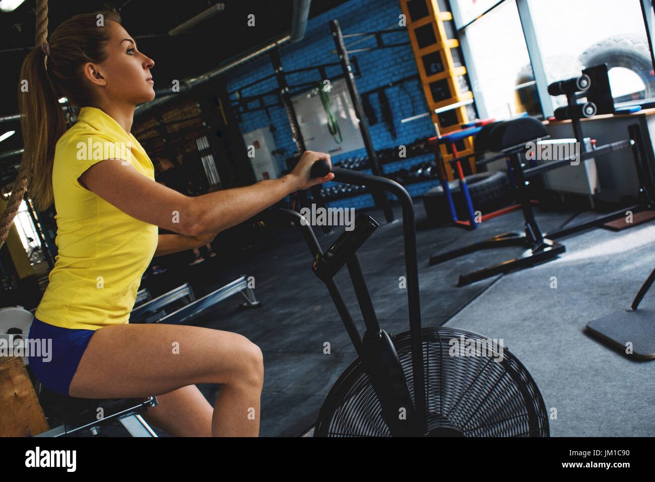Cardio workout on a stationary bike. Girl in fitness club. Stock Photo