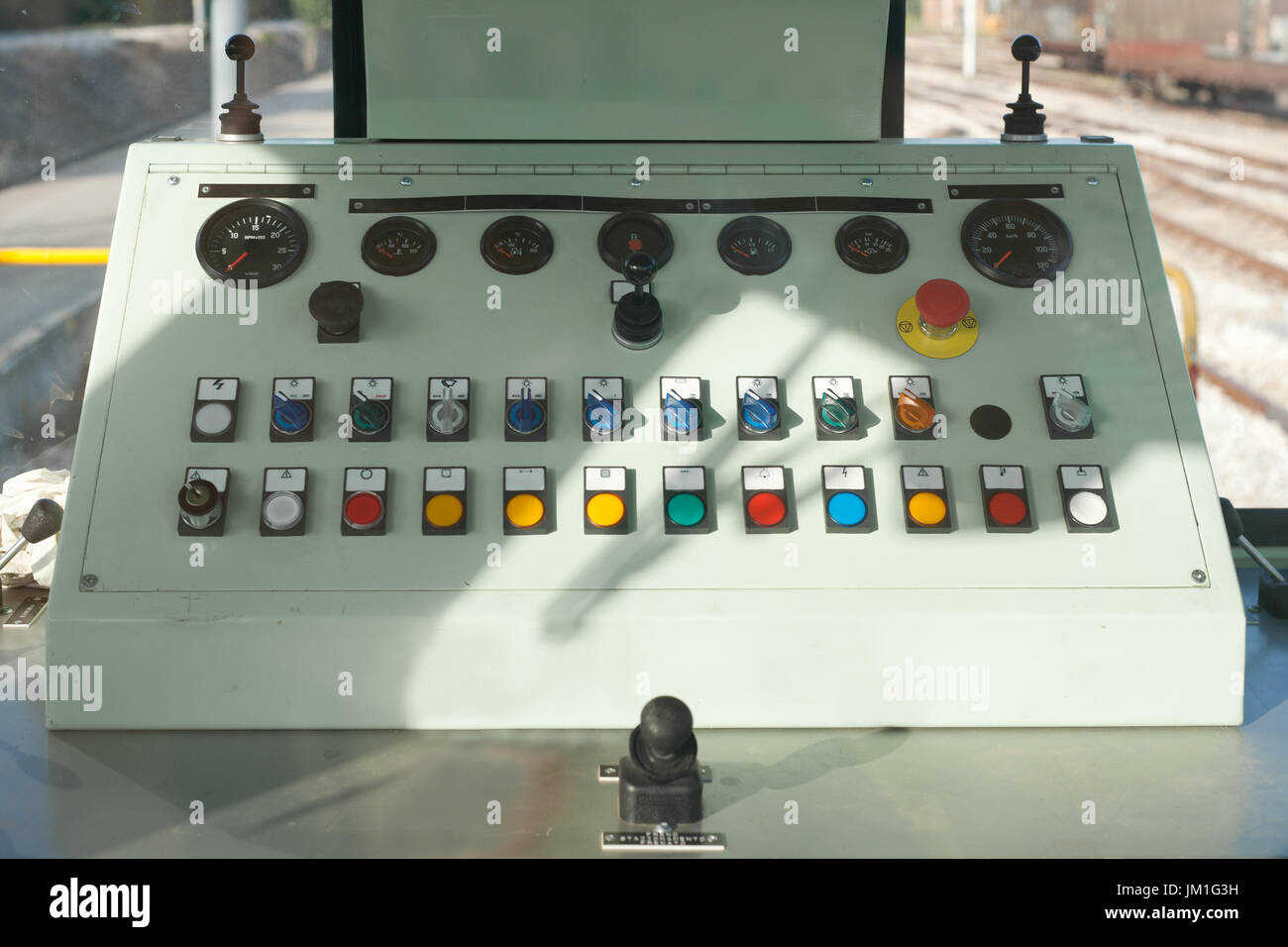 Train guide control panel with buttons and knobs and levers in a freight train stationed at the train depot Stock Photo