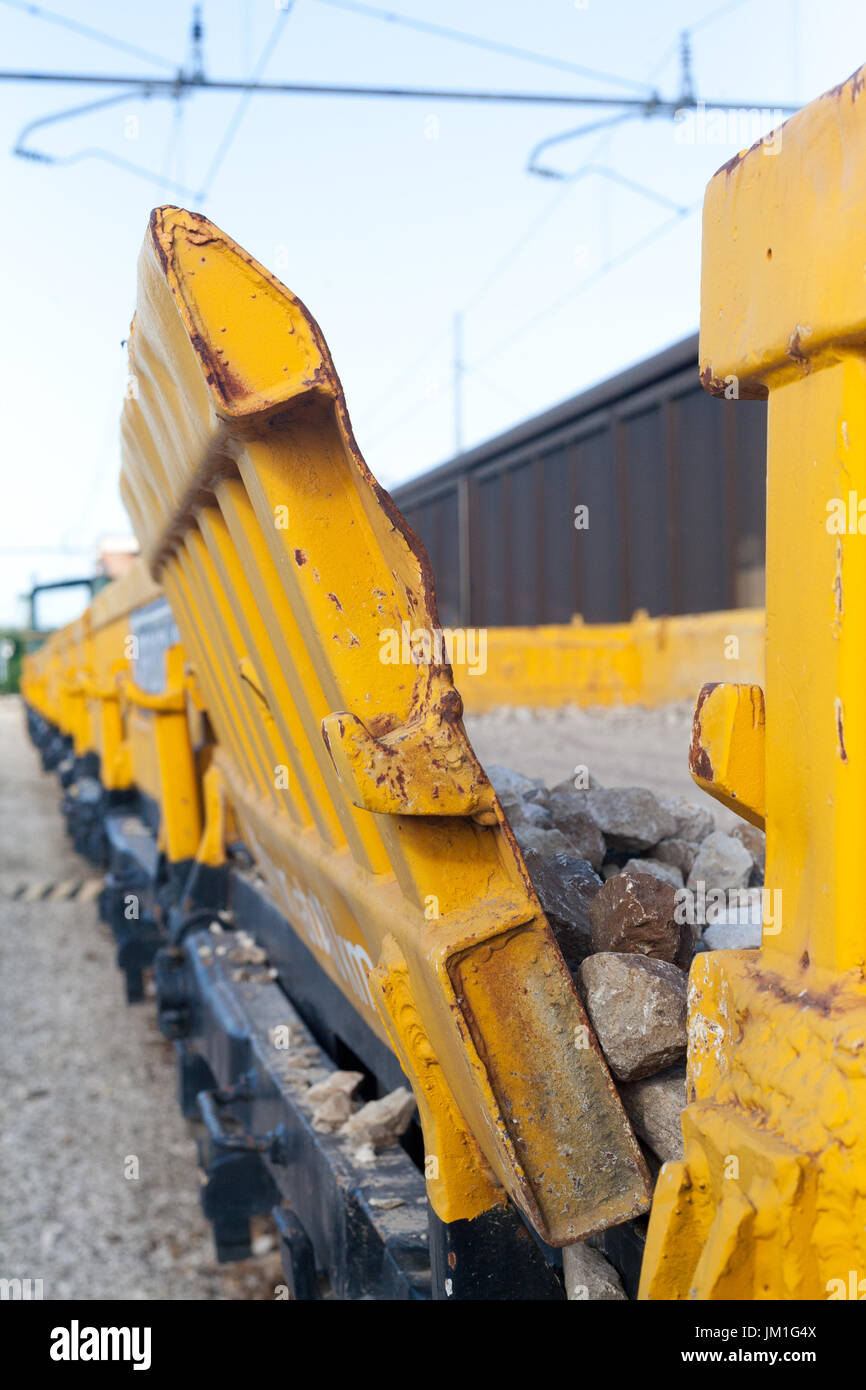 Yellow stone transport freight train wagon in railway depot Stock Photo