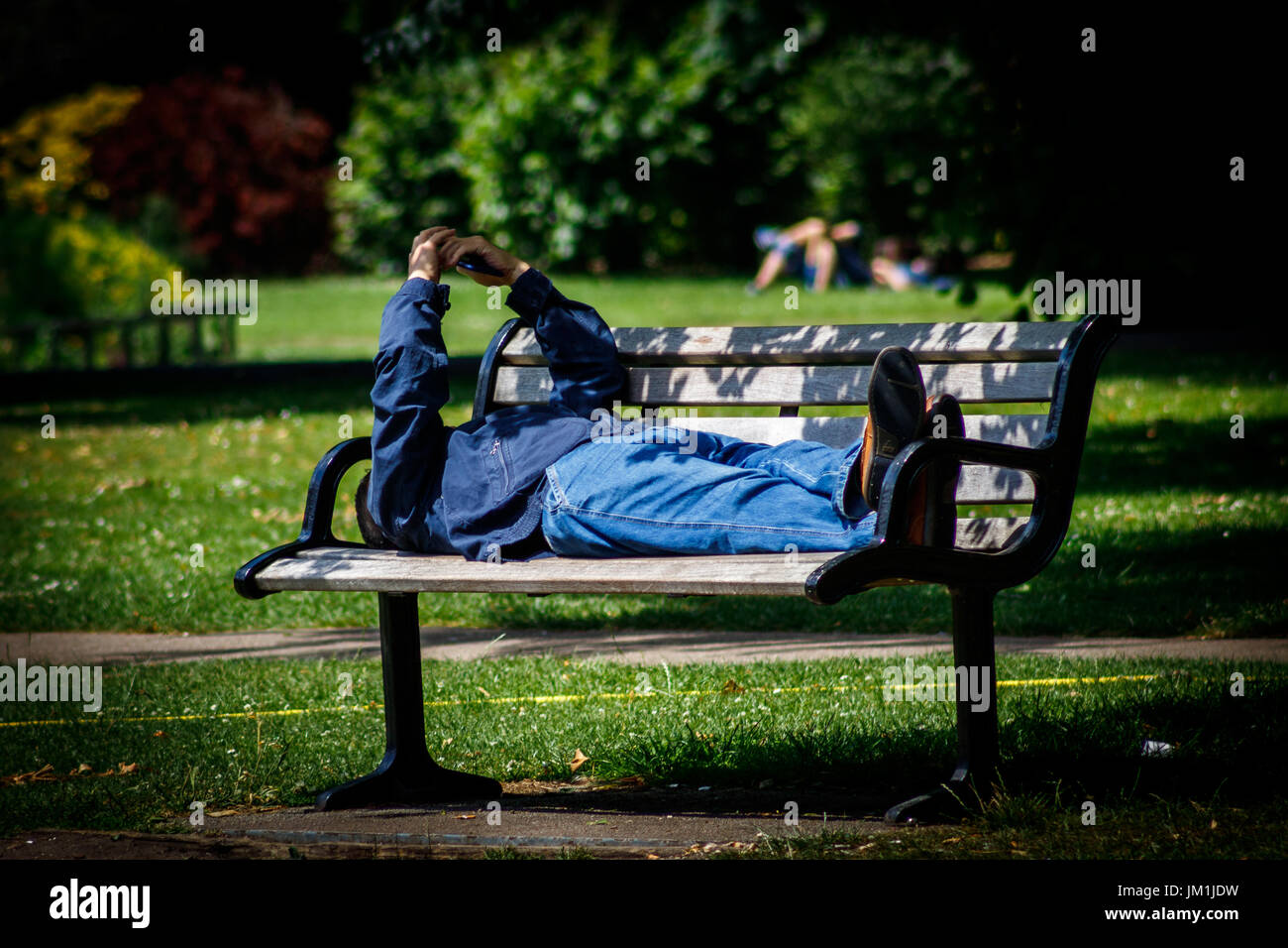 Man sleeping on a bench Stock Photo - Alamy