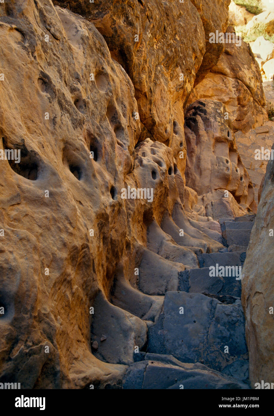 Acoma Pueblo, Grants, New Mexico, USA; Old trail up rocks. Modern steps beside rock-cut hand and toe holds. Stock Photo
