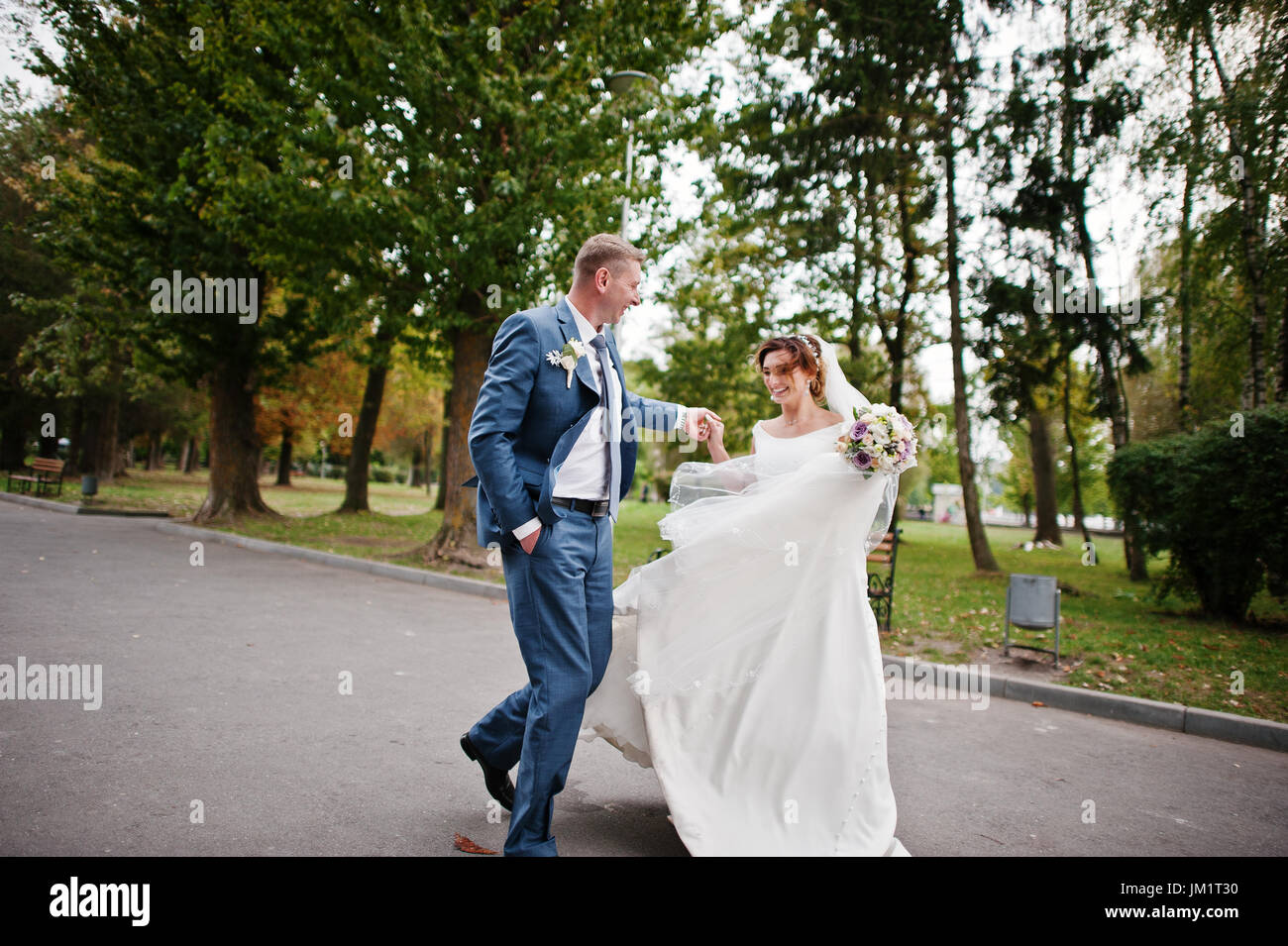 Fabulous young wedding couple posing in the park on the sunny day Stock ...