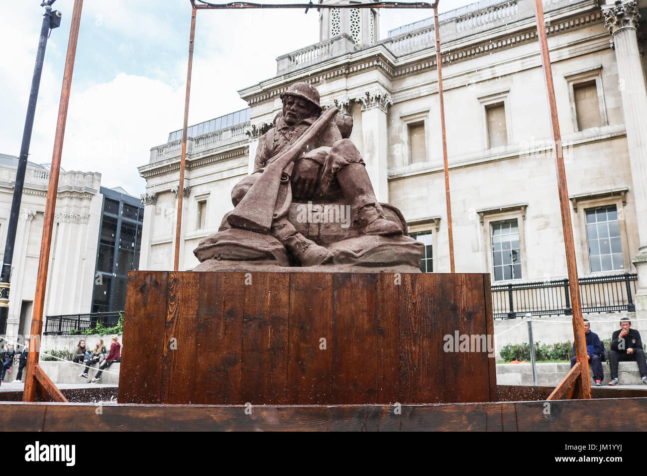 London, UK. 25th July, 2017. The Mud Soldier sculpture in Trafalgar Square created  from mud and sand from Flanders Fields  to mark the start of the Battle of Passchendaele in Belgium on July 31, 1917. The art installation by  artists, Damian and Killian Van Der Velden will slowly dissolve as it is exposed to rain to symbolise  the quagmire and muddy trenches experienced by Allied soldiers.Credit: amer ghazzal/Alamy Live News Stock Photo