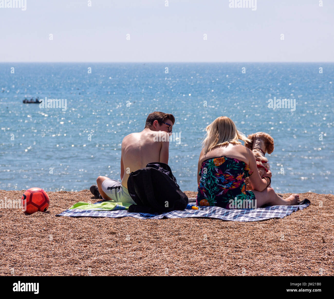 West Bay, Dorset, 25th July 17 Visitors enjoy glorious sunshine on the beach at West Bay, Dorset, where the series 'Broadchurch' was filmed. Credit: South West Photos/Alamy Live News Stock Photo