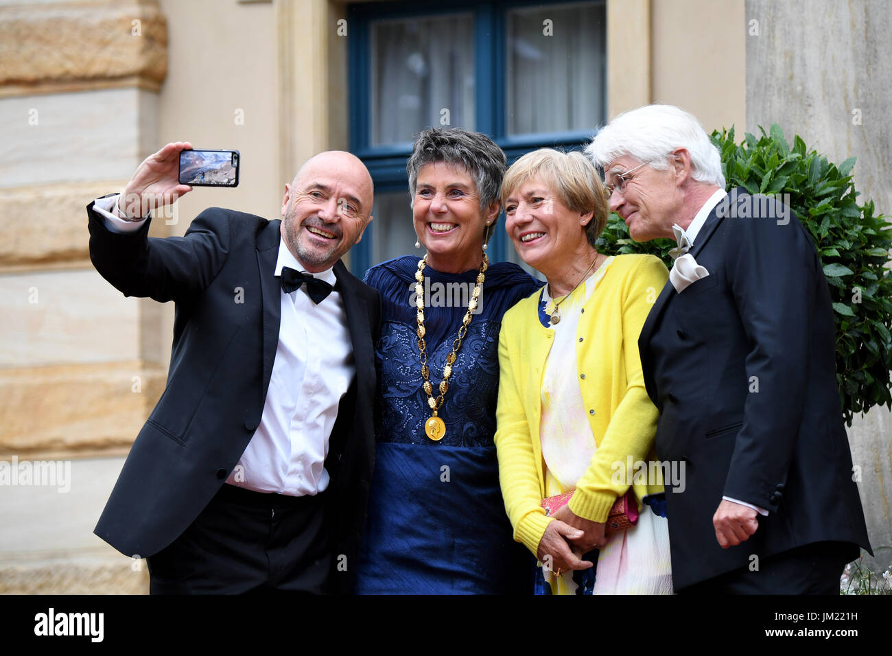 Bayreuth, Germany. 25th July, 2017. The former skiers Christian Neureuther (l), his wife Rosi Mittermaier (2.f.r), mayoress of Bayreuth, Brigitte Merk-Erbe (Bayreuther Gemeinschaft, 2.f.l) and her husband Thomas Erbe pose at the opening of the Bayreuth Festival 2017 in Bayreuth, Germany, 25 July 2017. The festival opens with the opera 'Die Meistersinger von Nuernberg' (The Master-Singers of Nuremberg). Photo: Tobias Hase/dpa/Alamy Live News Stock Photo