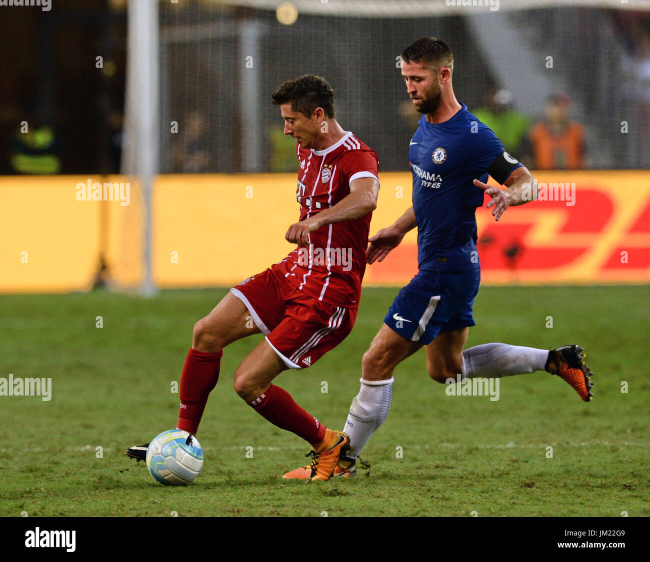 Singapore, Singapore. 25th July, 2017. Robert Lewandowski of FC Bayern Munich (L) dribbles past Gary Cahill of Chelsea FC (R) during the International Champions Cup match between FC Bayern Munich and Chelsea FC in Singapore, 25 July 2017. Photo: Mohammed/dpa/Alamy Live News Stock Photo