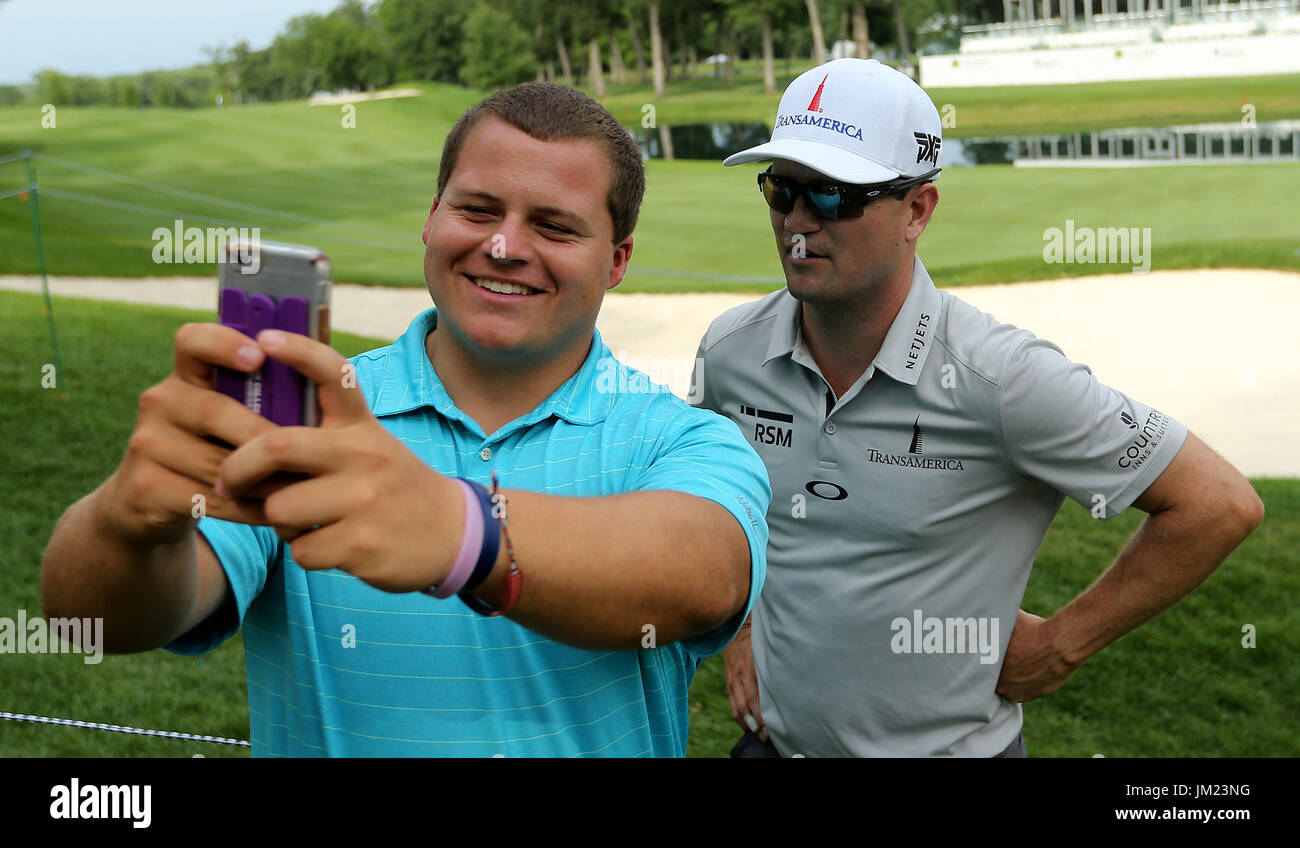 July 11, 2017 - Silvis, Iowa, U.S. - Jordan Anderson of Paxton, IL., takes his picture with forrmer John Deere Classic champion Zach Johnson (2012) of Cedar Rapids, on the 18th green, Tuesday, July 11, 2017, after his practice round  at TPC Deere Run in Silvis. (Credit Image: © John Schultz/Quad-City Times via ZUMA Wire) Stock Photo