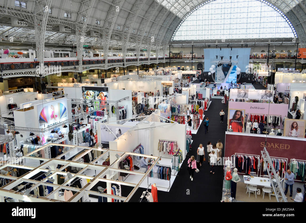 Clothing stands at Pure London, Olympia, London, UK. Pure London, the UK's leading trade fashion exhibition opened its doors 23-25th July 2017, featuring two halls of trade stands from leading fashion and accessories designers, lectures from industry experts, and fashion shows on two different catwalks throughout each day. Fashion buyers were out in force to see the new season's collections. 25th July 2017. Credit: Antony Nettle/Alamy Live News Stock Photo