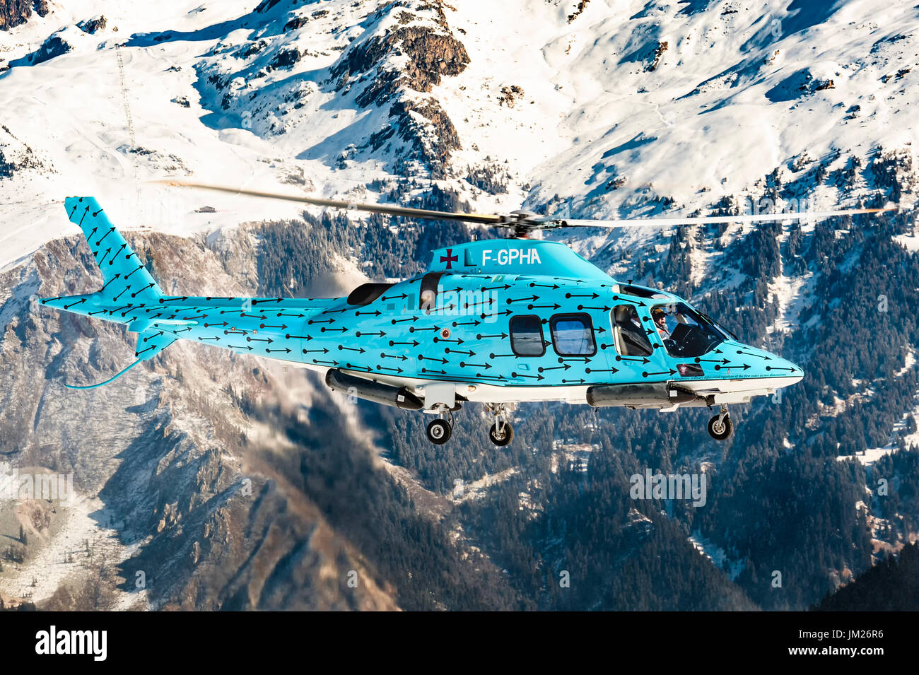 COURCHEVEL, FRANCE- February 25, 2017 During winter holiday, skiers arrives at Courchevel Altiport with Agusta A109 F-GPHA, Light blue helicopter Stock Photo
