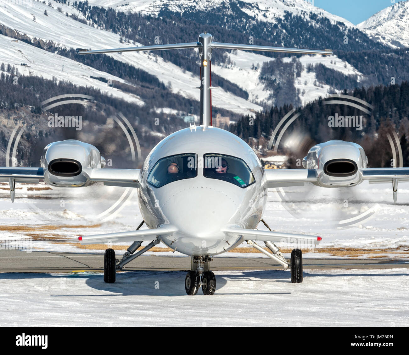 Taxiing over snow to parking at Samedan Engadine Airport Stock Photo