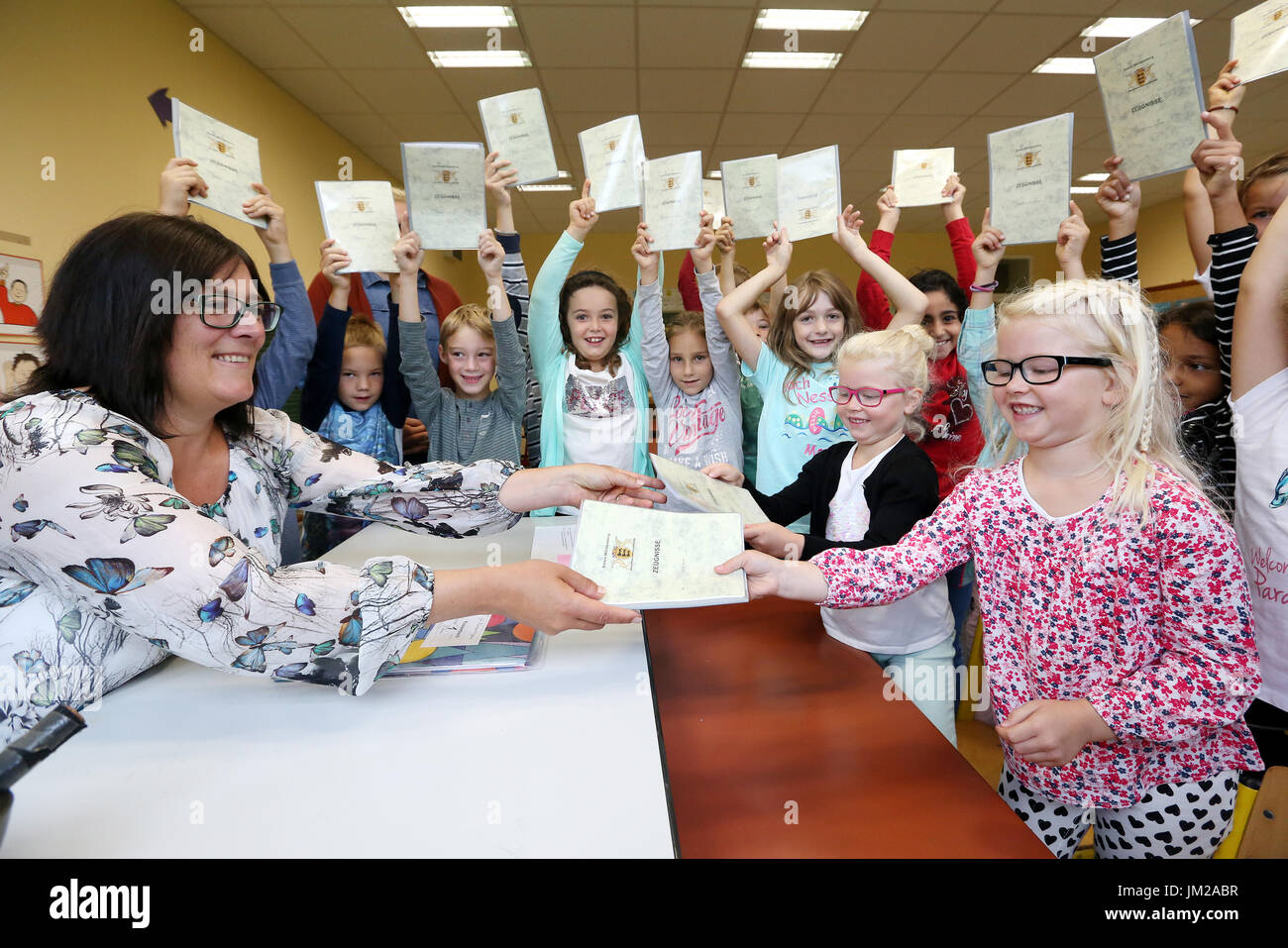 Birgit Kohler (L), 1st grade teacher of Durmentingen Elementary, gives certificates to children in the state of Baden-Württemberg, Germany, 26 July 2017. Students are packing their certificates and finally leaving the classrooms. Summer vacations start for more than 1.5 million students in Baden-Württemberg. Photo: Thomas Warnack/dpa Stock Photo