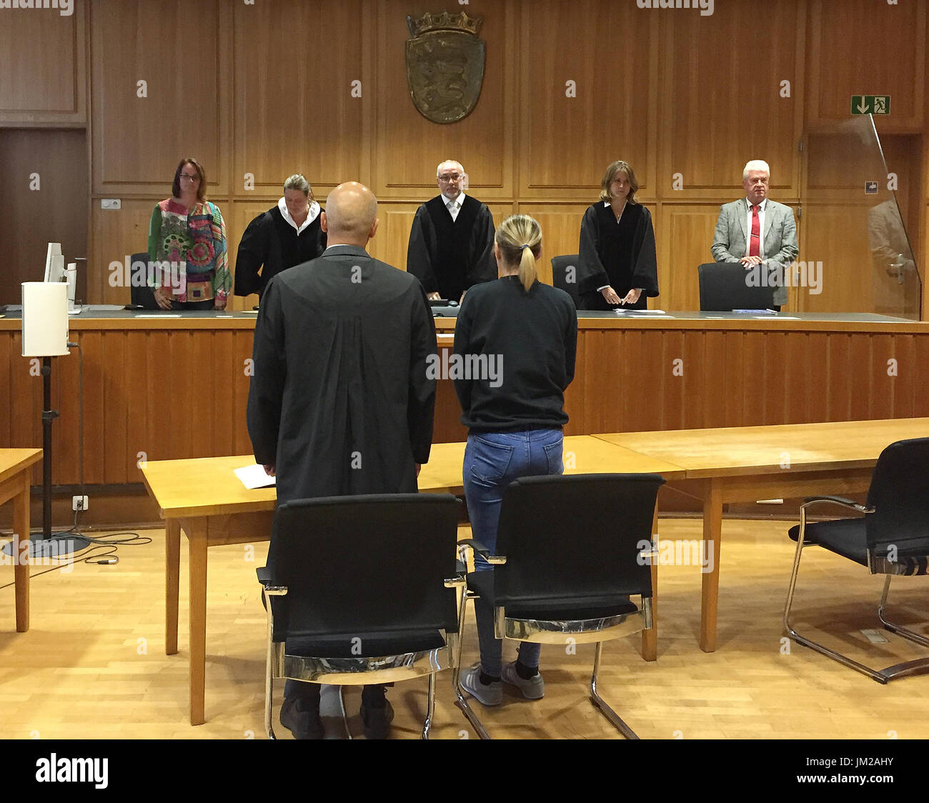 The accused (C, right) in a murder trial pictured next to her lawyer during the handing down of