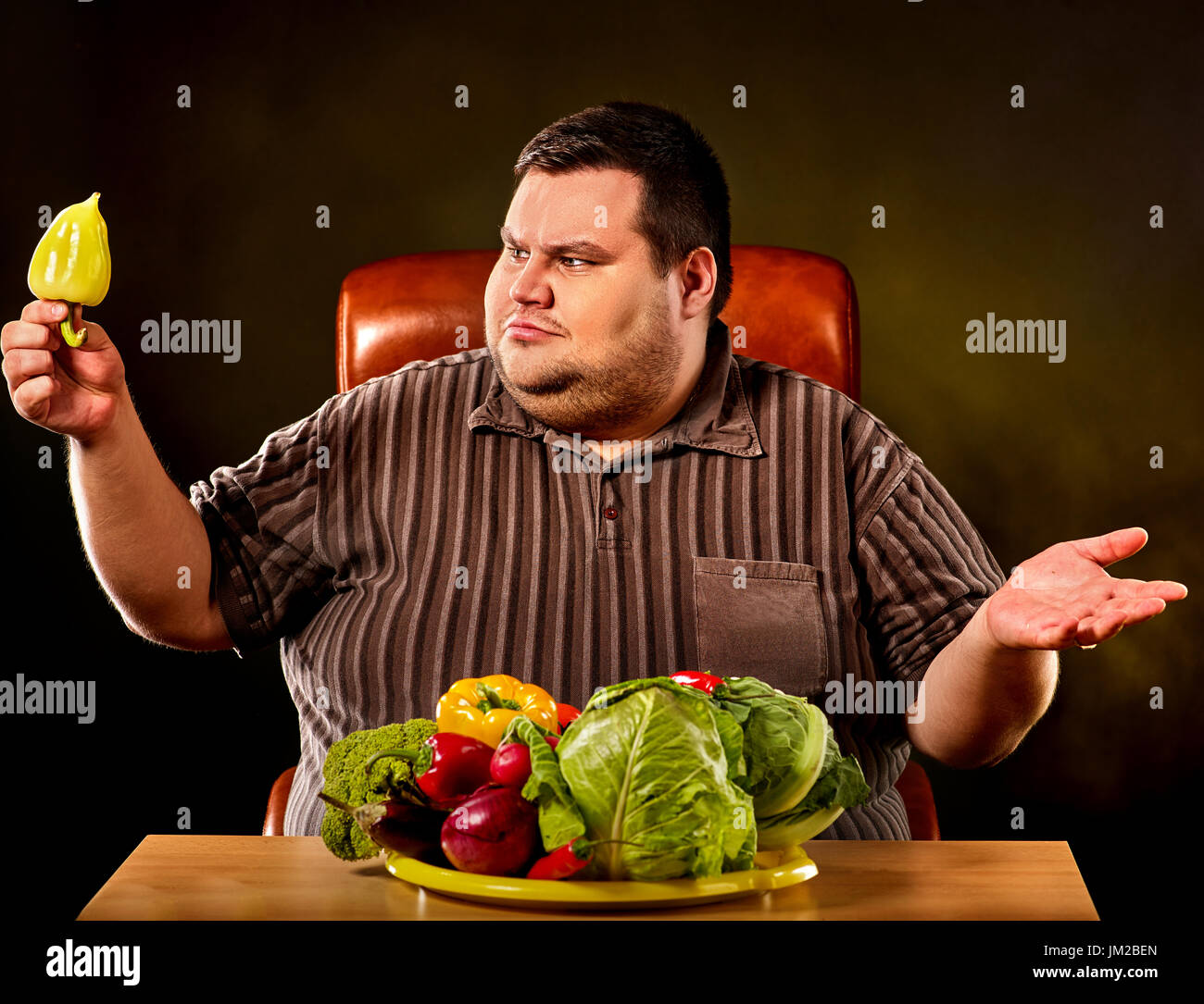 Diet fat man eating healthy food . Healthy breakfast with vegetables. Stock Photo