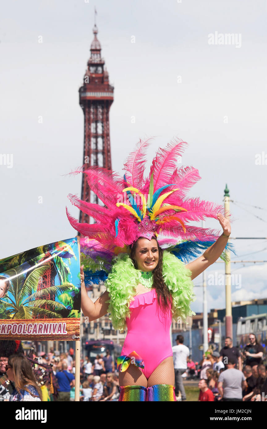 Attractive young woman wearing feather boa and head dress taking part in the Blackpool international carnival Stock Photo