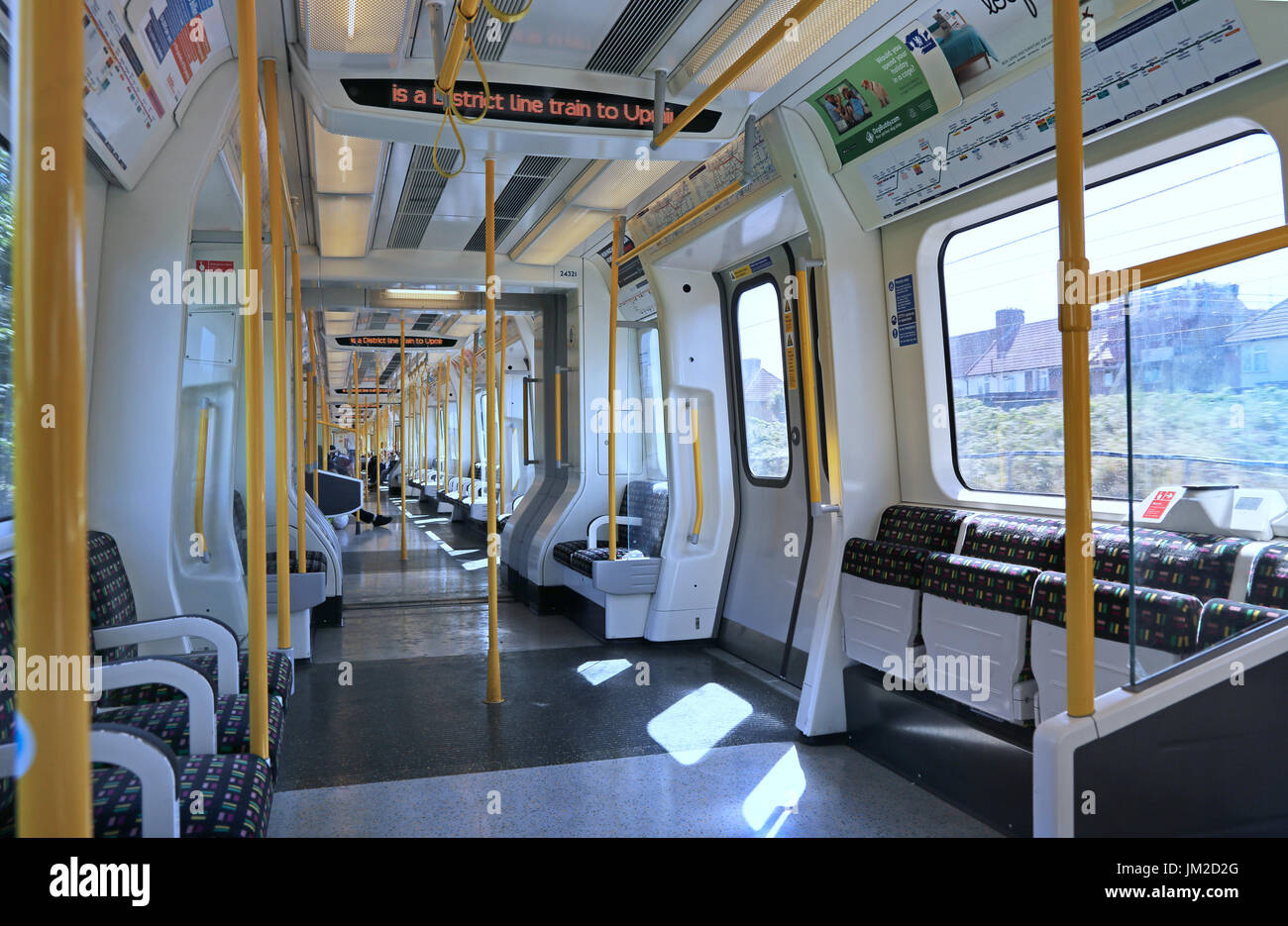 Interior of a new S7 carriage on London Underground's District Line - running above ground in East London, UK. Shows empty seats and destination sign. Stock Photo
