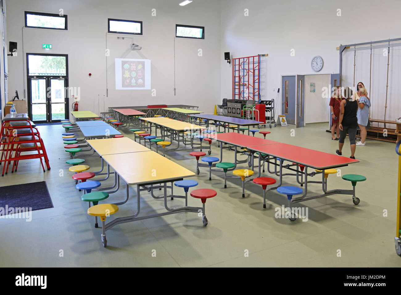 Interior of main hall in a newly built London Primary School. Shows folding tables laid out for school lunch. Stock Photo