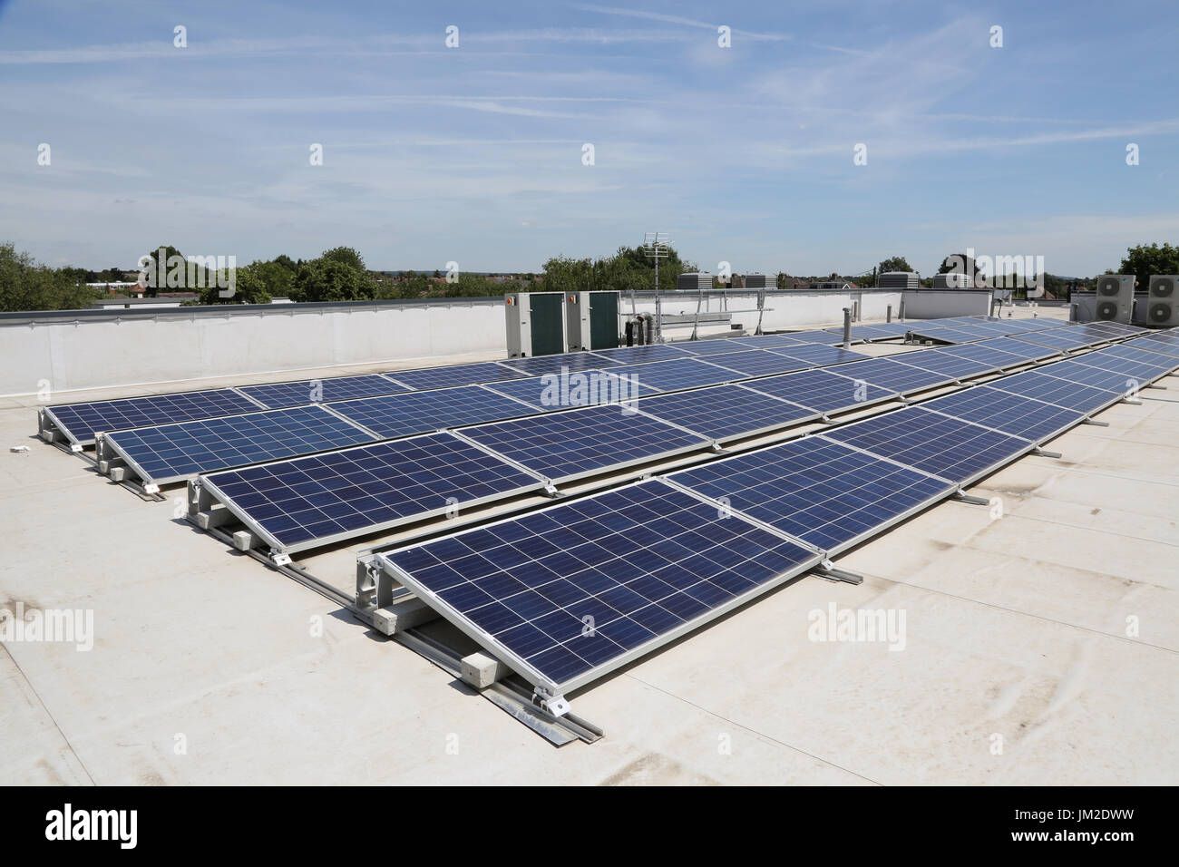 PV solar panels on the flat roof of a new primary school in Essex, UK Stock Photo