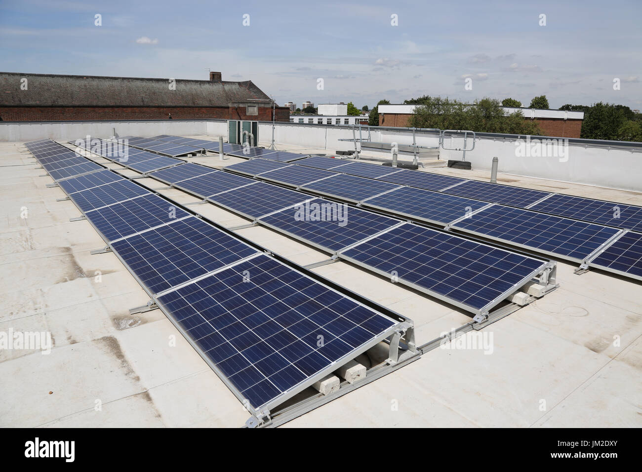 PV solar panels on the flat roof of a new primary school in Essex, UK Stock Photo