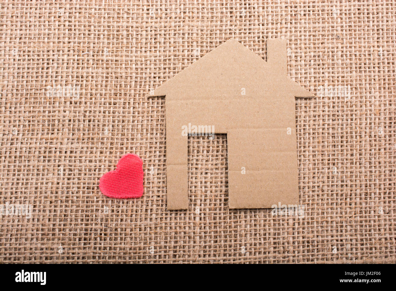 Heart shape beside paper house with a canvas background Stock Photo - Alamy