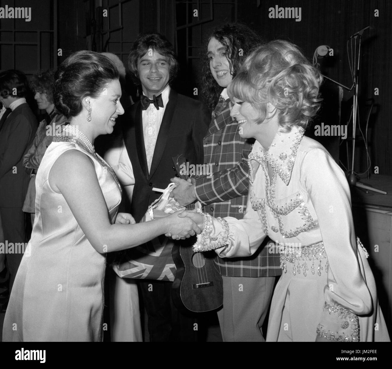 Princess Margaret, the President of the Invalid Children's Aid Association (ICAA), meets singer Dusty Springfield (r) at the London Palladium, scene of this year's Save Rave charity show which aided the ICAA. Looking on are entertainers Lou Christie and Tiny tim (in check coat). Stock Photo
