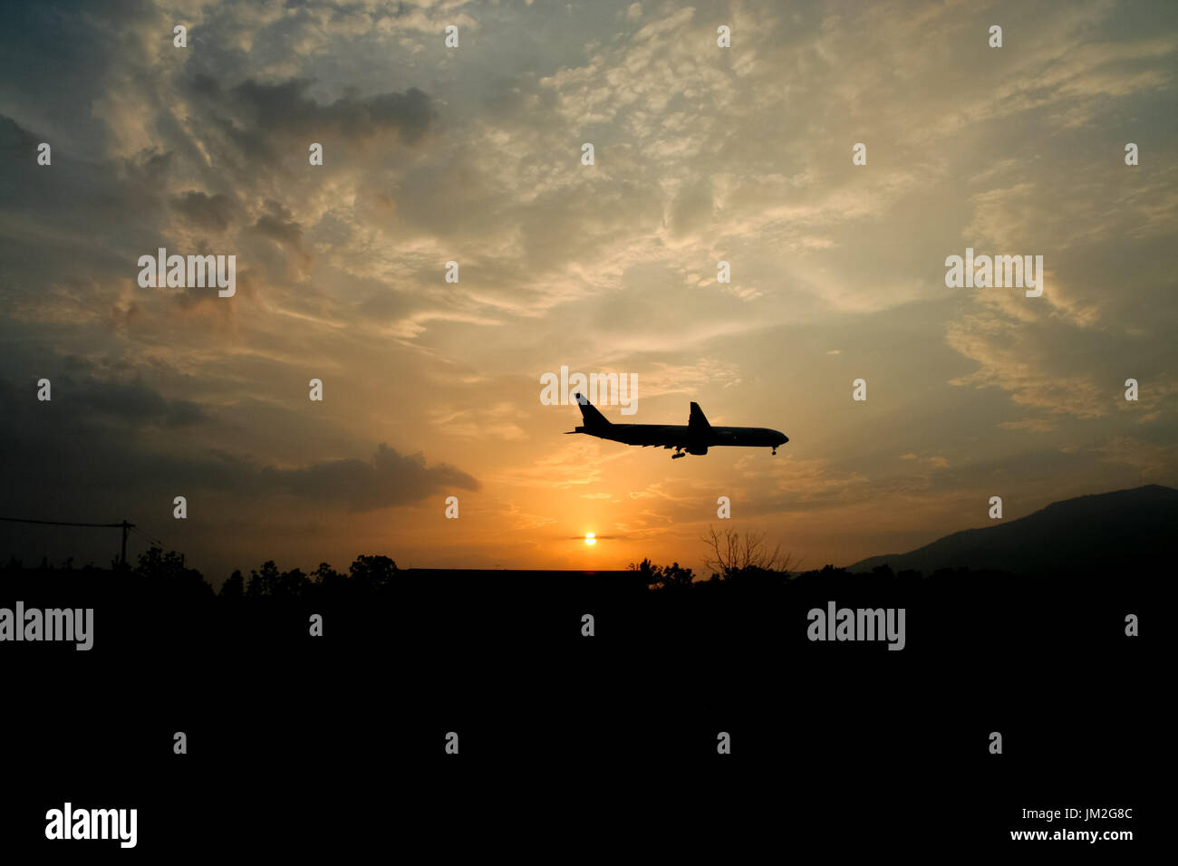Big Airplane Landing with Yellow sky sunset background Stock Photo - Alamy